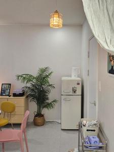a kitchen with a refrigerator and a table and a plant at 스테이149 in Hyomoktong-Ilgu +38 photos
