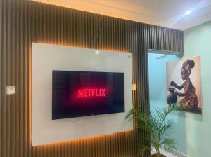 a flat screen tv on a wall in a room at Ivory Max in Ikeja