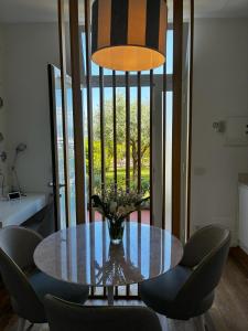 a dining room table with chairs and a vase of flowers at About Italy Holiday Rooms and Apartments in Portovenere +168 photos