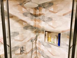 a bathroom with a shower with a tiled wall at Elegant & Cozy Retreat Home, City Center Gem, At the Seaside, Steps from the Tram in Konak +89 photos