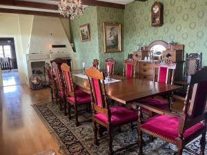 a dining room with a wooden table and chairs at Thorsagården in Listerby +12 photos