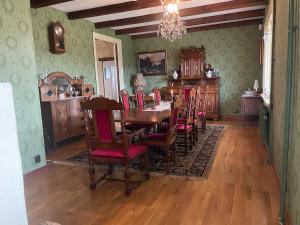 a dining room with a wooden table and chairs at Thorsagården in Listerby