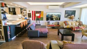 a living room filled with furniture and a kitchen at Elegant & Cozy Retreat Home, City Center Gem, At the Seaside, Steps from the Tram in Konak