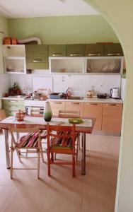 a kitchen with a table and chairs in a kitchen at Catherine Seaside Apartment in Ouranoupoli +17 photos