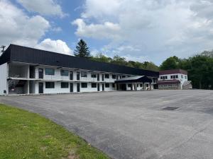 a large white building with a parking lot at Raystown Country Lodge in Huntingdon