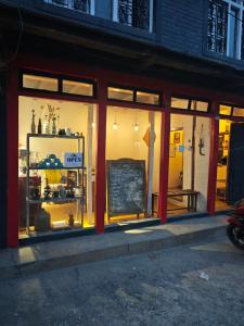 a store front with a chalkboard in the window at Gatlang Backpackers in Trisūli Bāzār