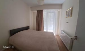 a bedroom with a bed and a window at Nerse's Apartment in Borjomi +17 photos