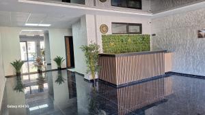 a lobby with potted plants on the wall in a building at Nerse's Apartment in Borjomi