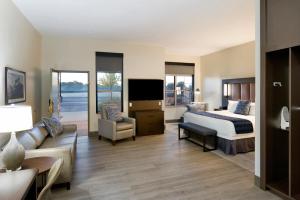 a hotel room with a bed and a couch at ClubHouse Hotel Sioux Falls in Sioux Falls +70 photos