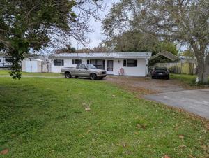 a house with a car parked in a yard at Small Town Florida in Jensen Beach