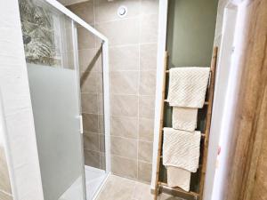 a shower with a glass door and towels in a bathroom at Cocon d'Amour & Spa in Le Thoronet +12 photos