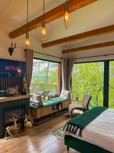 a bedroom with a bed and a fireplace at Doza de Verde Retreat&Spa Bran-Adults Only in Sohodol +117 photos