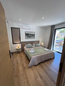 a bedroom with a bed with two towels on it at Aria Linda in Belgodère +36 photos
