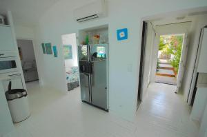 a kitchen with a stainless steel refrigerator in a room at Sur la plage in Lumio