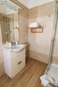 a bathroom with a sink and a shower at B&B Le Palme in Grottammare +21 photos
