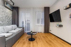 a living room with a couch and a table at Deribasivska 20 Nice Apartment in Odesa +6 photos
