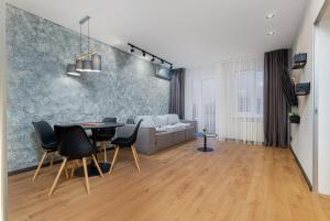 a living room with a table and chairs and a couch at Deribasivska 20 Nice Apartment in Odesa