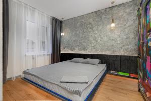 a bedroom with a bed in a room at Deribasivska 20 Nice Apartment in Odesa