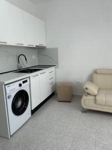 a kitchen with a washing machine and a sink at SeaView 7 Floor -No Elevater in Durrës
