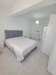 a white bedroom with a large bed in it at SeaView 7 Floor -No Elevater in Durrës