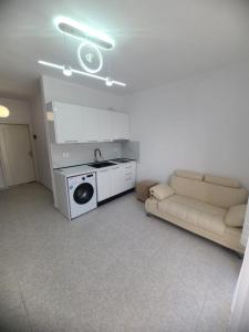a living room with a couch and a washing machine at SeaView 7 Floor -No Elevater in Durrës