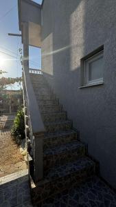 a staircase leading up to a building with a window at Appartemani EMIE in Donji Štoj