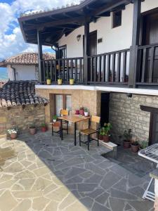 a patio with a table and chairs in front of a house at Guest House Genti in Berat +22 photos