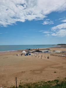 a beach with a bunch of people on the sand at Apartament MARY in Constanţa