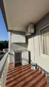 a kitchen with a refrigerator on the side of a building at Appartemani EMIE in Donji Štoj