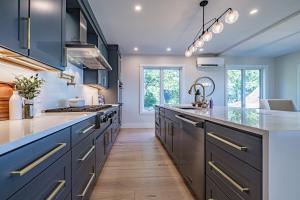 a large kitchen with blue cabinets and a sink at Modern Ocean Front Home 4 bed, 5 bath Freeport in Freeport +48 photos