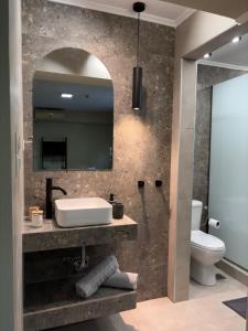 a bathroom with a sink and a mirror at Filemial House in Agios Mamas