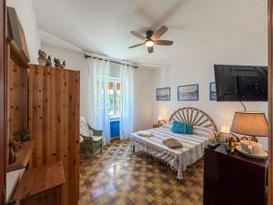 a bedroom with a bed and a ceiling fan at Budoni Casa Vacanze - MAR DEI CORALLI in Budoni