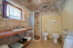 a bathroom with a shower and a toilet and a sink at Masseria Copertini in Vernole