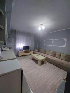 a living room with a couch and a coffee table at Ariana Guest House in Prizren