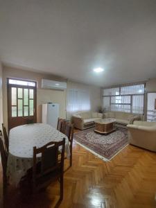 a large living room with a table and a couch at Ariana Guest House in Prizren