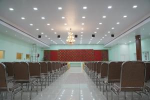an empty hall with chairs and a chandelier at Sri Laxmi Grand Convention in Tuni