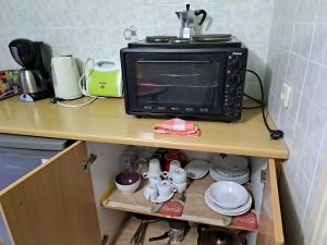 a microwave oven sitting on top of a kitchen counter at attic sea view studio in karmiris studios in Zakynthos