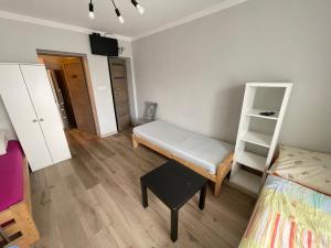 a small room with a bed and a shelf at Na Papierni in Klucze