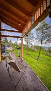 a hammock on a porch with a view of a field at Doza de Verde Retreat&Spa Bran-Adults Only in Sohodol