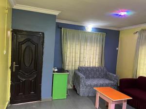 a living room with a couch and a chair at Electra Serviced 1 Bedroom Apartment, Lagos in Iju Junction