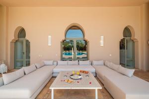 a living room with a white couch and a table at Luxury Palace in Marrakesh in Marrakesh