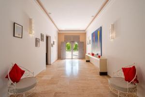 a hallway with two chairs and a hallway with a hallwayngth at Luxury Palace in Marrakesh in Marrakesh