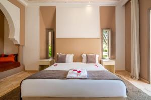 a bedroom with a large white bed with two towels at Luxury Palace in Marrakesh in Marrakesh +59 photos