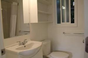a white bathroom with a sink and a toilet at 6 bedroom house in Victoria