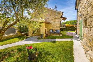 a stone house with a garden and a patio at Villa Palazza in Pazin