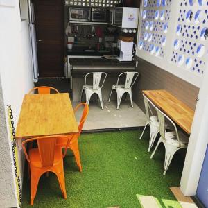 a room with two tables and chairs and a kitchen at iHostel Aldeota in Fortaleza