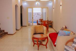 a living room with a couch and a table at Villa Abo Ishak in Luxor +83 photos
