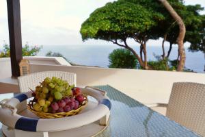 a bowl of fruit on a table on a balcony at Dammuso Vento Del Sud in Pantelleria
