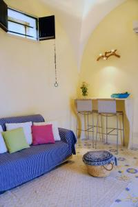 a living room with a couch and a table at Dammuso Vento Del Sud in Pantelleria