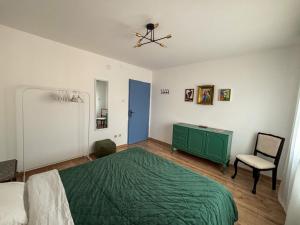 a bedroom with a green bed and a green dresser at Dabfly Guesthouse & Outdoor Adventures in Ražanj +21 photos